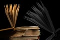 stack of old books with opened one on top on dark background. Old books in the library. Bookshelf shop. Knowledge publications, Royalty Free Stock Photo