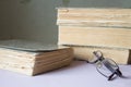 Stack of old books with a pair of glasses Royalty Free Stock Photo