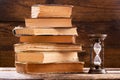 Stack of old books and retro hourglass Royalty Free Stock Photo