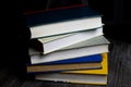 Stack of old books on round wood table with reading light during night Royalty Free Stock Photo