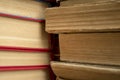 A stack of old books shooting up close. Ancient books in a stack. Old paper in books - a large stack - macrophoto.