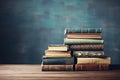 Stack of old books on the table on blue background with copy space. AI generated Royalty Free Stock Photo