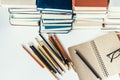 Stack of old books, textbook, notebook, glasses and pencils on white table in office background for education concept Royalty Free Stock Photo