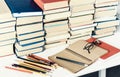 Stack of old books, textbook, notebook, glasses and pencils on white table in office background for education concept Royalty Free Stock Photo