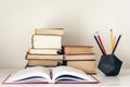 Stack of old books, textbook and pencils in office background for education concept