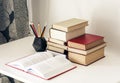 Stack of old books, textbook and pencils in office background for education concept