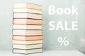 stack of old colored books on shelf and green background with text & x22;Book sale %& x22; Royalty Free Stock Photo