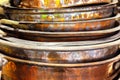A stack of old copper bowls, deformed and frayed. Royalty Free Stock Photo