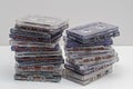 Stack of old dirty audio cassettes on the white shelf. Royalty Free Stock Photo