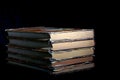 A stack of old dusty books on a dark background Royalty Free Stock Photo