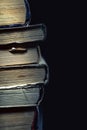 Stack of old dusty shabby books on black background Royalty Free Stock Photo