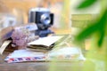 Stack of old family photos, vintage photographs of 50s, 40s, black retro accordion camera on wooden table, concept of genealogy,