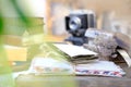 Stack of old family photos, vintage photographs of 50s, 40s, black retro accordion camera on wooden table, concept of genealogy,