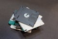 Stack of old floppy disks stacked on a table, obsolete disk media Royalty Free Stock Photo