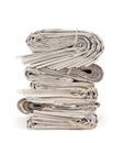 A stack of old newspapers isolated on white