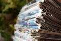 A stack of old newspapers lie on a table