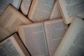 A stack of old opened books laying on the floor. Selective focus