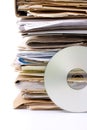 Stack of old paper files and modern cd archive