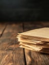 A stack of old papers sits on a weathered wooden table suggesting history knowledge and the passage of time Royalty Free Stock Photo