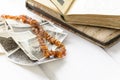 Stack of old photographs with amber necklace Royalty Free Stock Photo