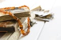 Stack of old photographs with amber necklace on photo album on white background Royalty Free Stock Photo