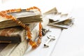 Stack of old photographs with amber necklace on photo album on white background Royalty Free Stock Photo