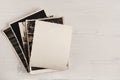 A stack of old photos with an empty reverse side on a wooden background. Vertical position Royalty Free Stock Photo