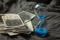 Stack old photos and hourglass on table. Postcard rumpled and dirty vintage Royalty Free Stock Photo