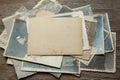 Stack old photos on table. Mock-up blank paper. Postcard rumpled and dirty vintage Royalty Free Stock Photo