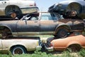 Stack of old rusting cars in a breakers yard