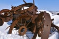 Stack of old rusty steel rims buried in deep snow