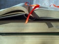 Stack of old thick books close up. Bookmark on the pages of an open book. The concept of scientific work, education Royalty Free Stock Photo
