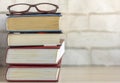 A stack of old thick books and glasses on the table Royalty Free Stock Photo