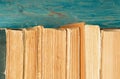 Stack of old and used hardback books or text books on blue wooden background Royalty Free Stock Photo