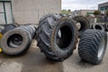 Stack of old used tires of different sizes and types in abandoned scrap yard. Royalty Free Stock Photo