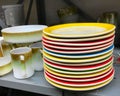 Stack of old used vintage colorful dinner plates dishes in thrift shop Royalty Free Stock Photo