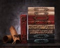 Stack old vintage books on shelf, and old paper scrolls manuscripts Royalty Free Stock Photo