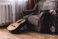 A stack of old vinyl records and acoustic wooden guitar with an amplifier are isolated on a brown background for a music Royalty Free Stock Photo