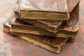 Stack of old and worn leather cover books with gold leaf embossing. Closeup Royalty Free Stock Photo