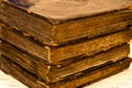 Stack of old and worn leather cover books with gold leaf embossing Royalty Free Stock Photo