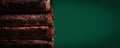 Stack of old worn leather covered books on malachite color background. Banner. Copy space