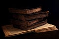 Stack of old worn shabby jewish books in leather binding on the open pages of Machzor in the dark. Closeup