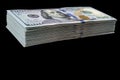 Stack of one hundred dollar bills isolated on black background. Stack of cash money in hundred dollar banknotes. Heap of hundred d Royalty Free Stock Photo