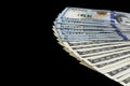 Stack of one hundred dollar bills. Stack of cash money in hundred dollar banknotes. Heap of hundred dollar bills isolated on black Royalty Free Stock Photo