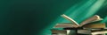 Stack of Open Books on a Green Background. Knowledge and Education Concept Royalty Free Stock Photo