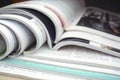 A stack of open glossy magazines lies on the table Royalty Free Stock Photo