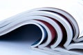 Stack of open glossy magazines on white background Royalty Free Stock Photo