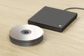 Stack of optical discs and optical drive Royalty Free Stock Photo