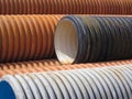 Stack of orange, black and white tube pipes Royalty Free Stock Photo