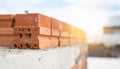 Stack of orange bricks on a concrete foundation at a construction site building unfinished Royalty Free Stock Photo